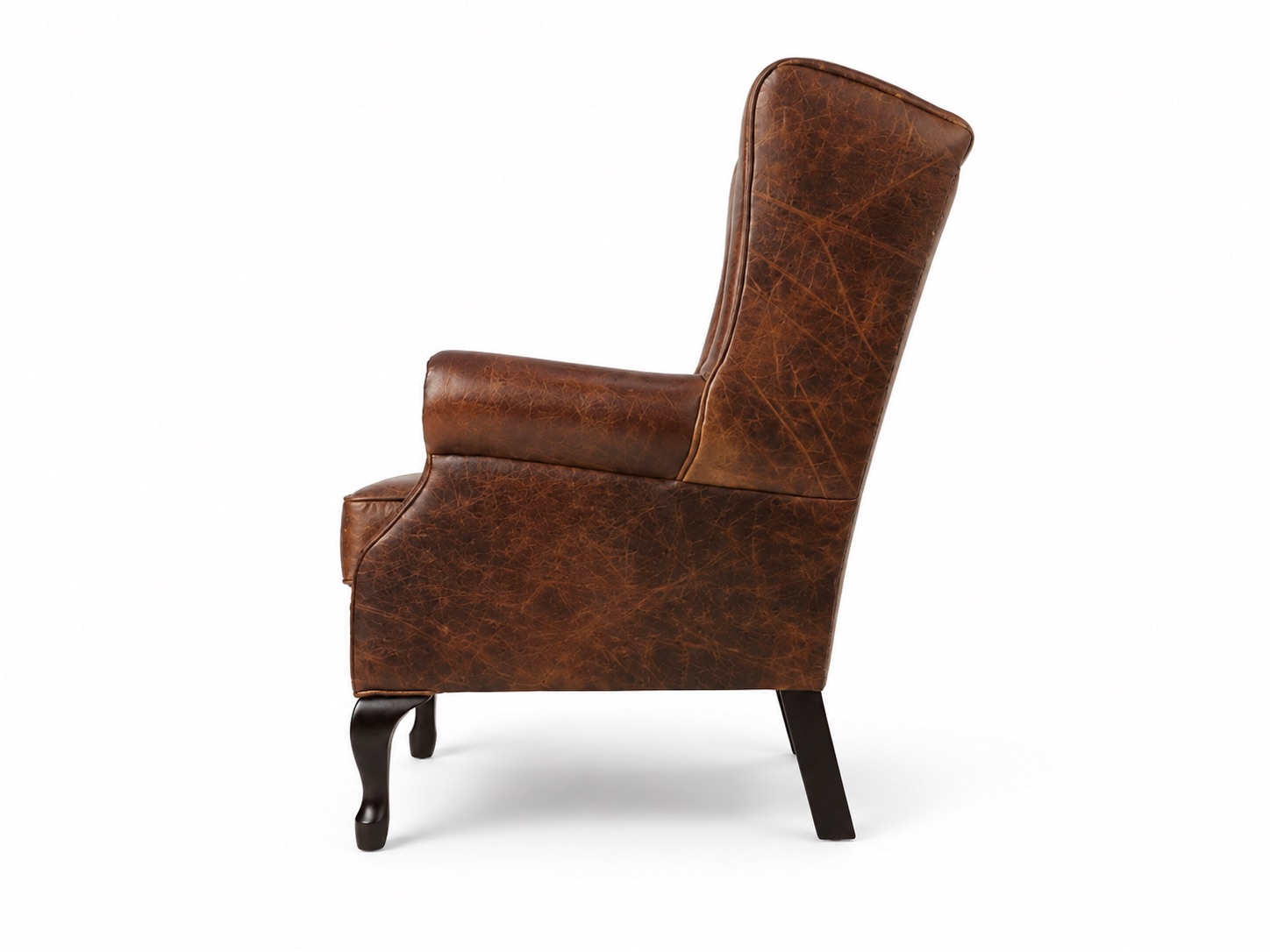 Brown leather wingback armchair side view