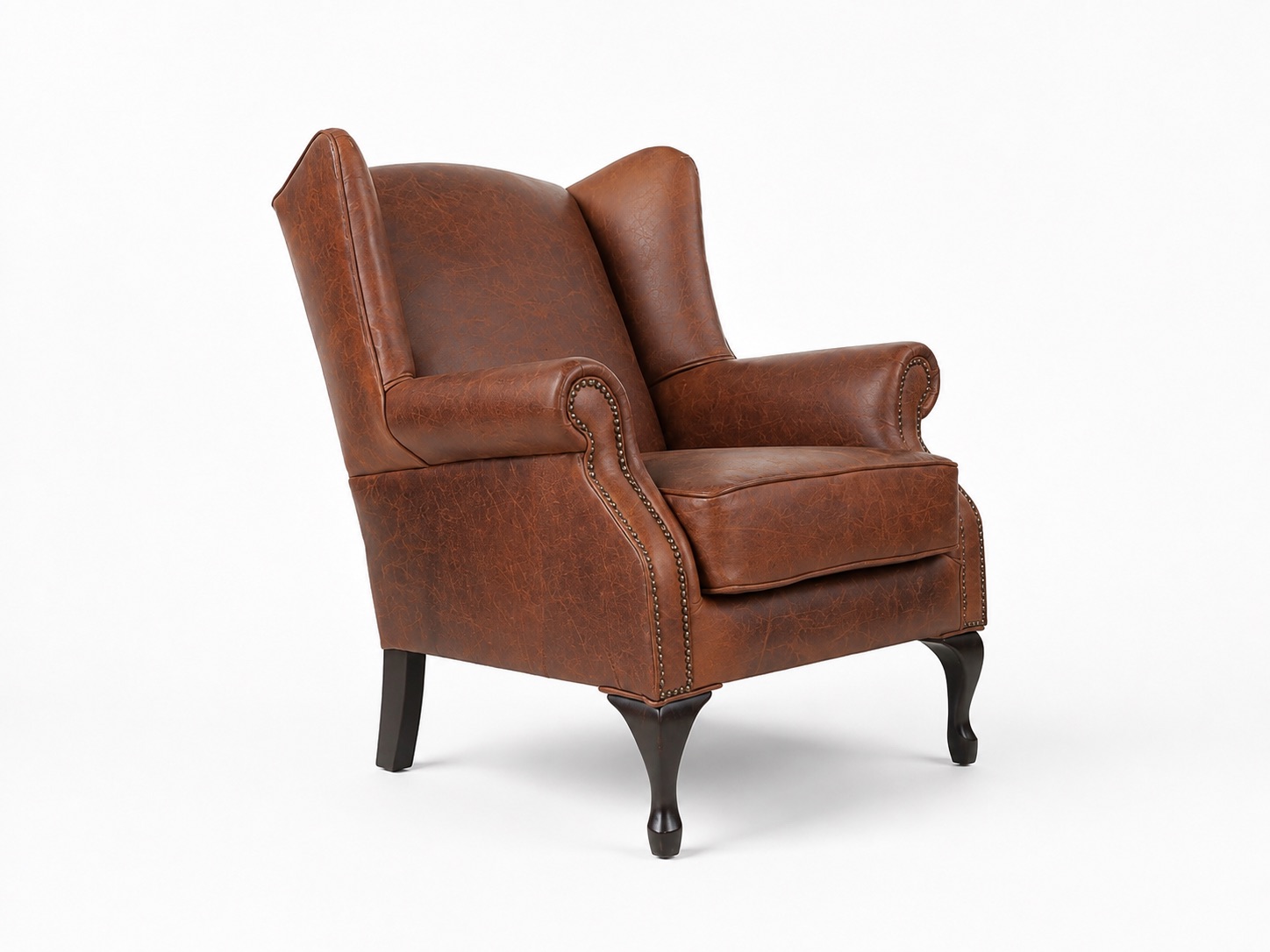 Brown leather wingback armchair angled front view