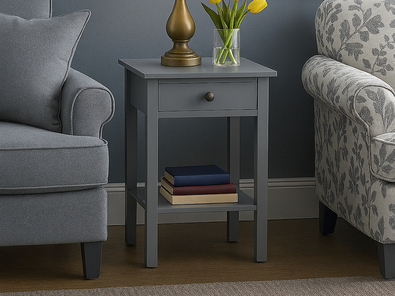 Grey Bella Pedestal beside two armchairs in a living room, with a lamp, tulips and books